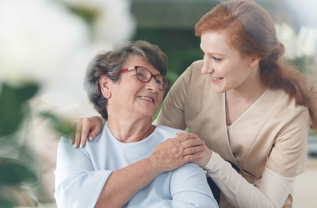 A young female nurse help a senior woman transition from assisted living to memory care.